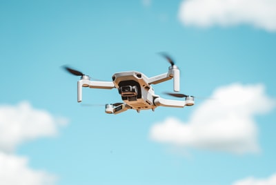 Black and white uav flying in the sky
